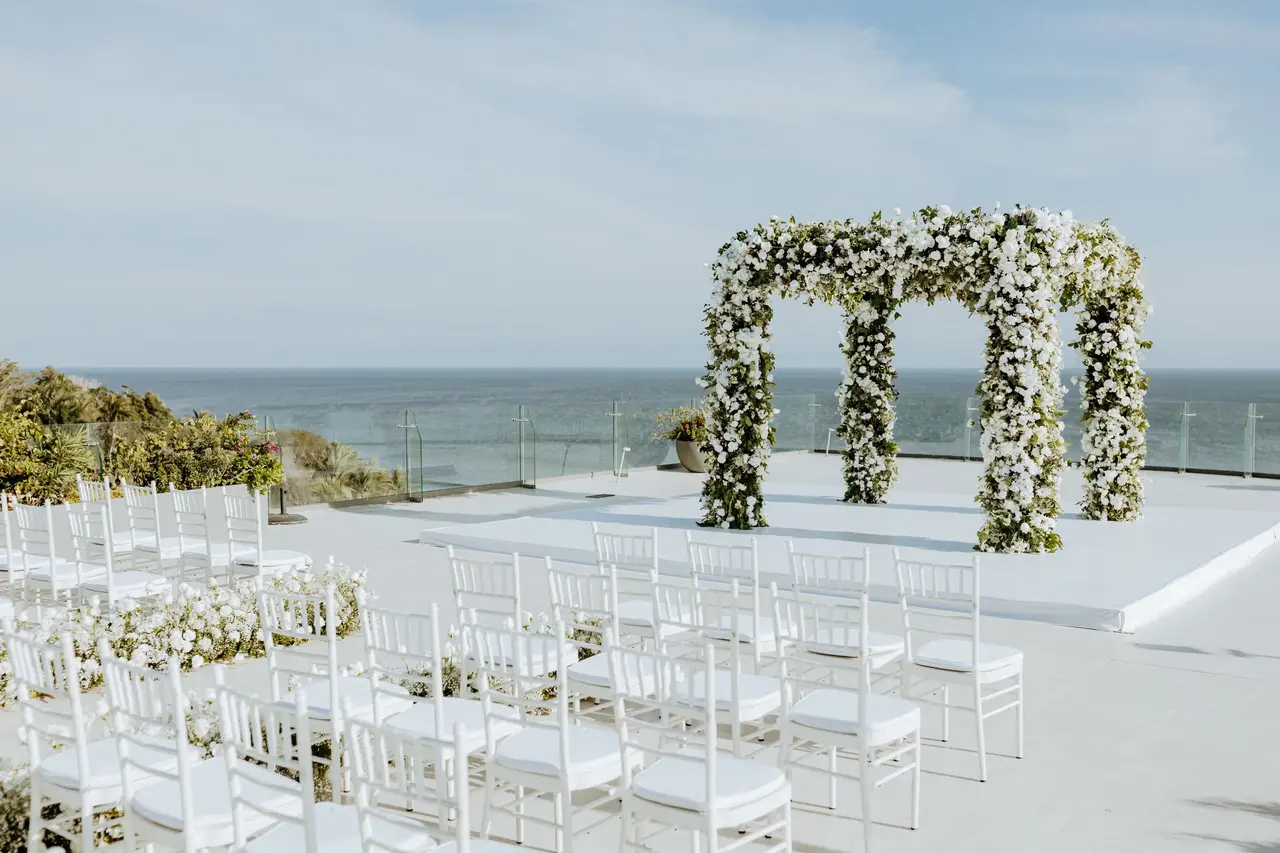 rooftop destination wedding set up floral arch and ocean view at an all Dreams Bahia Mita